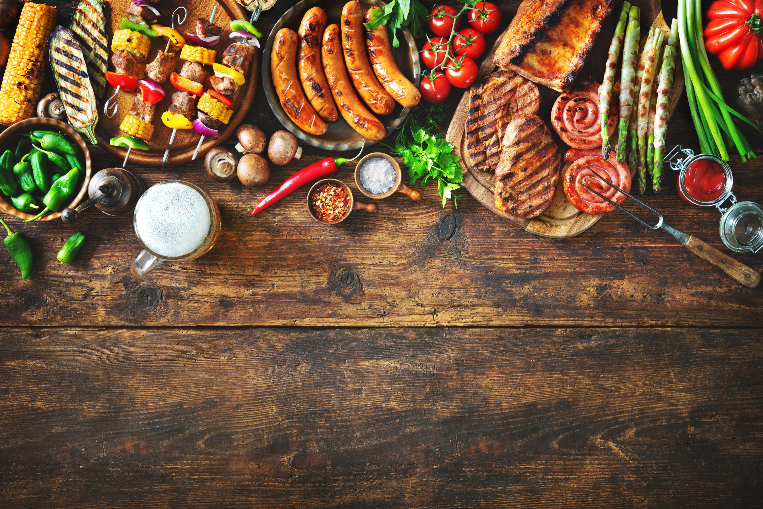 Grilled,Meat,And,Vegetables,On,Rustic,Wooden,Table